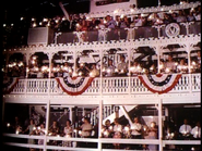 The Mark Twain Riverboat adorned with people holding sparklers