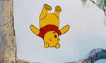 Winnie the Pooh is about to hit his head on the branch