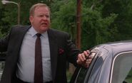 Ernest has Mayor Murdock's back while the car window is broken.