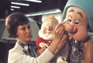 Burns painting the final touches on an animatronic for "Snow White's Adventures"