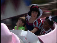 Cheyne Wolff and Shannon Sharpe riding Dumbo with Snow White.