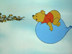 Pooh chasing the bees in Winnie the Pooh and the Honey Tree