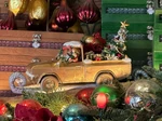 Plaza Point Holiday Shoppe Remodeled as a sleigh-like vehicle with its canopy removed and trunk filled with holiday decor. Santa also is seen driving.
