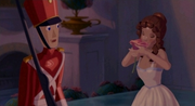 Ballerina smelling the pink rose when Tin Soldier is looking at her, confused.