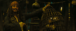 Jack in a cage, in Tia Dalma's shack, being traded by Jack Sparrow.