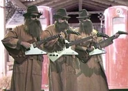 Caveman musicians in "I'm the Baby (Gotta Love Me)" music video