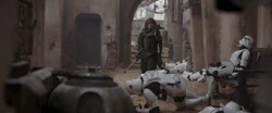 Jyn battles Stormtroopers in the streets of Jedha City.