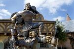 A statue showing Gaston and his friend in front of Gaston's Tavern in the Beauty and the Beast section of New Fantasyland.