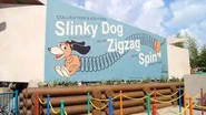 Slinky Dog Zig Zag Spin's logo on the edge of the ride.