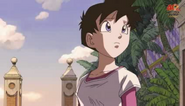 Videl looking up at Mr. Satan's golden statue