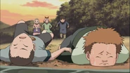 Choji lies on the ground.