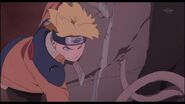 Boruto frees Naruto from the tree.