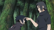 Sasuke having his forehead poke by Itachi.