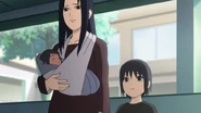 Sasuke being held by Mikoto.