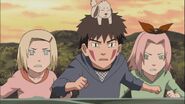 Akamaru trys to help Naruto get Yota out of Konoha.