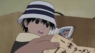 Inari sees that his grandfather has found Naruto's Ramen Coupon.
