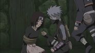 Kakashi about to free Rin from a genjutsu.