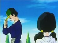 Videl looka at Gohan after he puts his cap back on