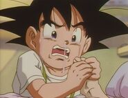 Goku Jr. cries as he holds his grandma's hand, and begs her not to leave him.