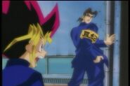 Showing Yugi that he beat up Joey and Tristan