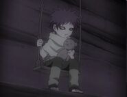 Gaara sitting on a swing.