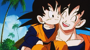 Goku laughs with Goten on his shoulder