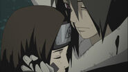 Rin being hugged by Obito.