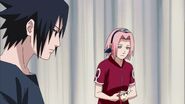 Sakura pilling an apple for Sasuke.