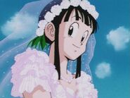 Chi-Chi smiles at her father while she wears her mother's wedding dress.