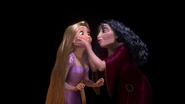 Gothel squishing Rapunzel's cheeks.
