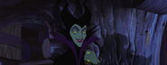 Maleficent grinning evilly as she and her goons ambush Prince Phillip at the good fairies' cottage.