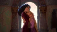 Gothel hugging Rapunzel who assures her she'll stay safe in the tower while she's gone.