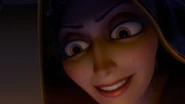 Gothel smiling evilly as she discovers that the golden flower's magic is in the baby princess's hair.