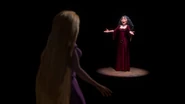 Gothel signaling Rapunzel to give her a hug.