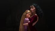 Gothel as Rapunzel embraces her.