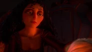 Gothel brushing a young Rapunzel's hair.