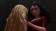Pretending to be sympathetic, Gothel tells Rapunzel she "loves" her.