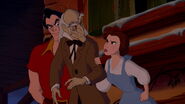 Gaston watching as Belle confronts D'Arque for declaring her father insane.