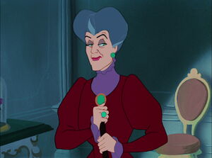 Lady Tremaine about to trip the royal herald with her cane, in order to prevent Cinderella from trying on the slipper.