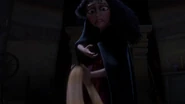 Gothel scooping up Rapunzel's hair after it was cut.