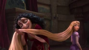 Gothel stroking Rapunzel's hair.