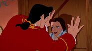 Gaston pinning Belle on her door to "win" her approval.