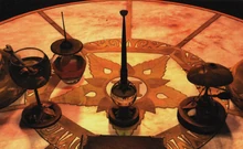 233 GehnDesk.jpg (277 KB) Closeup to Gehn's desk; a jar with ink-activating formula, Gehn's pen rest, Gehn's pipe, and a beetle-shaped inkwell can be seen.