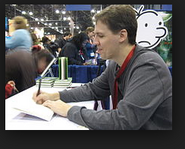 Jeff Kinney signing books.