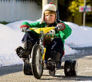 Rowley riding a big-wheel.