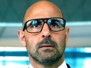 Joshua Joyce (Stanley Tucci) en Transformers: La era de la extinción.