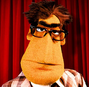 Presentador de noticias en El show de los Muppets (doblaje original).