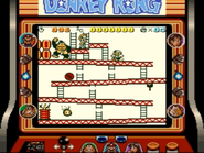 Mario traversing the stage 25m of the game Donkey Kong for Game Boy, as seen on the Super Game Boy for SNES.