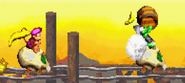 A light blue Klank throwing a barrel at Dixie and Diddy Kong, also riding a Skull Cart behind the enemy, as seen in the game Donkey Kong Country 2 for GBA.