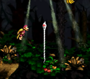 Dixie Kong jumping towards a Ghost Rope, as seen in the game Donkey Kong Country 2: Diddy's Kong Quest for SNES.